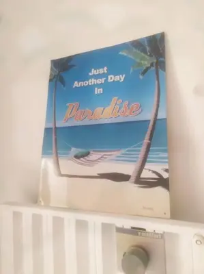 a book sitting on top of a white shelf at Appartement proche croisette avec parking et climatisation in Cannes