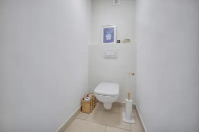 a white bathroom with a toilet in the corner at Beau 2 chambres TERRASSE, COEUR DU SUQUET-entre Port et Plages A2B238 in Cannes