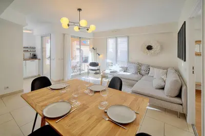 a living room with a table and a couch at Beau 2 chambres TERRASSE, COEUR DU SUQUET-entre Port et Plages A2B238 in Cannes