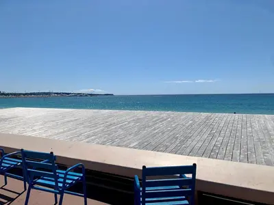 two blue chairs sitting next to the ocean at Beau 2 chambres TERRASSE, COEUR DU SUQUET-entre Port et Plages A2B238 in Cannes