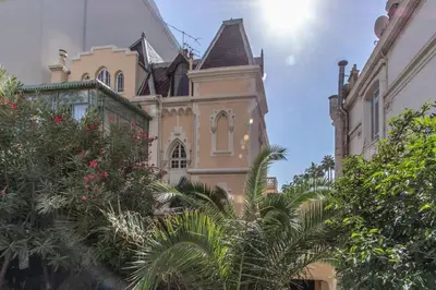 an old building with trees in front of it at Croisette: 2BDR Apartment in Cannes