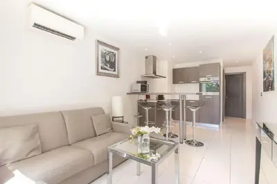 a living room with a couch and a table at Croisette: 2BDR Apartment in Cannes