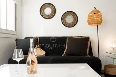 a living room with a black couch and a table at 