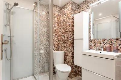 a bathroom with a toilet and a shower and a sink at 