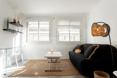 a living room with a black couch and a table at 