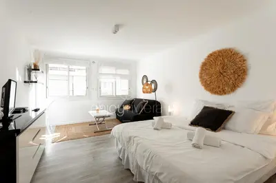 a white bedroom with a large bed in a room at 