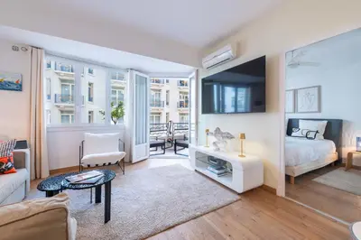 a living room with a bed and a couch at 2-Bedroom Apartment with Terrace and Side Sea View in Cannes