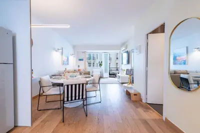 a dining room and living room with a table and chairs at 2-Bedroom Apartment with Terrace and Side Sea View in Cannes