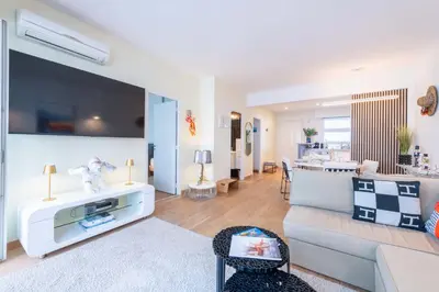 a living room with a couch and a table at 2-Bedroom Apartment with Terrace and Side Sea View in Cannes