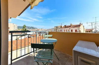 a view from a balcony with a table and chairs at L'ALIZEE avec jolie terrasse vue sur la ville, charmant studio dans le centre de Cannes in Cannes