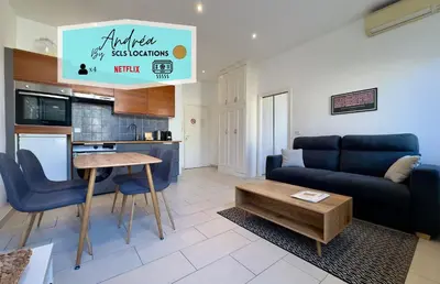 a living room with a couch and a table at Andréa By SCLS Locations in Cannes