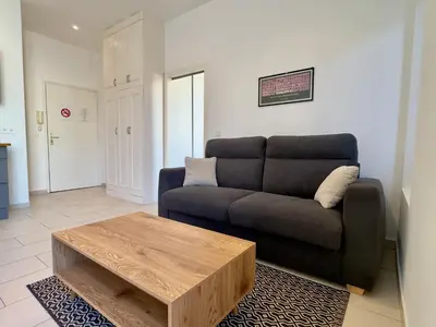a living room with a couch and a coffee table at Andréa By SCLS Locations in Cannes
