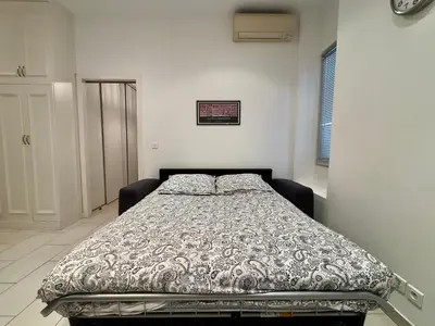 a bedroom with a bed in a white room at Andréa By SCLS Locations in Cannes