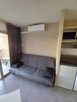 a room with a bed in the corner of a room at appartement les pieds dans l'eau in Cannes