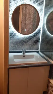 a bathroom with a sink and a mirror at appartement les pieds dans l'eau in Cannes