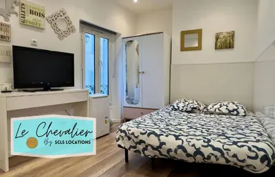 a small bedroom with a bed with a tv on it at Mini Studio - Le Chevalier By SCLS Locations in Cannes
