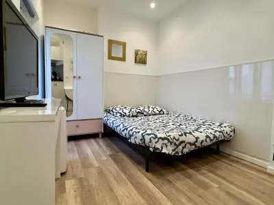 a small bedroom with a bed and a mirror at Mini Studio - Le Chevalier By SCLS Locations in Cannes