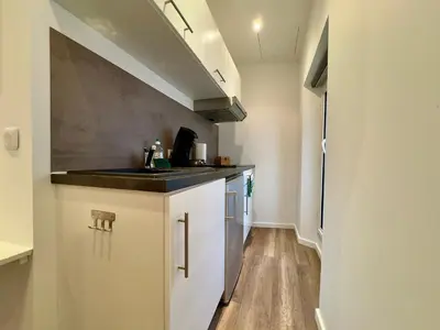 a small kitchen with a sink and a counter at Mini Studio - Le Chevalier By SCLS Locations in Cannes