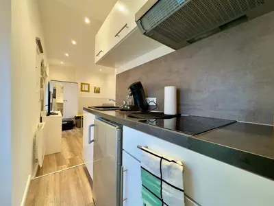 a kitchen with a counter top and a sink at Mini Studio - Le Chevalier By SCLS Locations in Cannes
