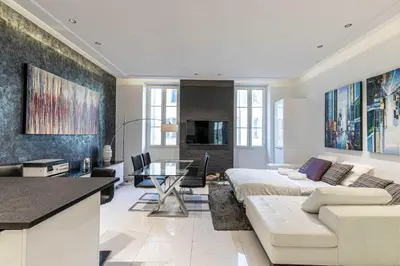 a living room with a bed and a couch at Large renovated studio - rue Hoche - Cannes center in Cannes