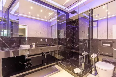a bathroom with a toilet and a glass shower at Large renovated studio - rue Hoche - Cannes center in Cannes