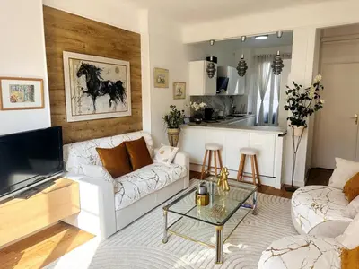 a living room with a white couch and a table at One Bedroom apartment in Cannes Center a few steps from the Croisette and the Martinez Hotel - 2032 in Cannes
