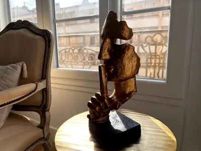 a statue sitting on a table next to a chair at One Bedroom apartment in Cannes Center a few steps from the Croisette and the Martinez Hotel - 2032 in Cannes