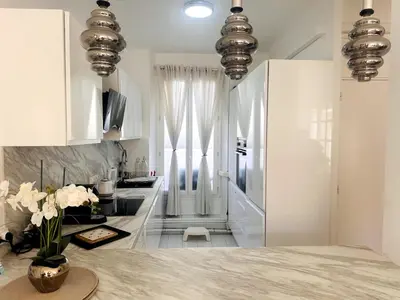 a kitchen with white cabinets and a counter top at One Bedroom apartment in Cannes Center a few steps from the Croisette and the Martinez Hotel - 2032 in Cannes