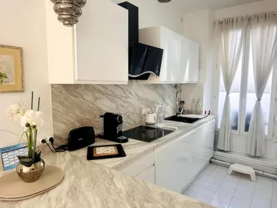 a kitchen with white cabinets and a counter top at One Bedroom apartment in Cannes Center a few steps from the Croisette and the Martinez Hotel - 2032 in Cannes