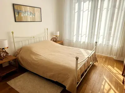 a bedroom with a bed and a large window at One Bedroom apartment in Cannes Center a few steps from the Croisette and the Martinez Hotel - 2032 in Cannes