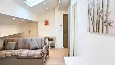 a living room with a couch and a table at Proche Carlton & Croisette, Appartement 401 - Palmazur Vacances in Cannes