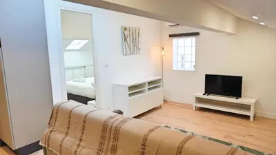 a living room with a couch and a television at Proche Carlton & Croisette, Appartement 401 - Palmazur Vacances in Cannes