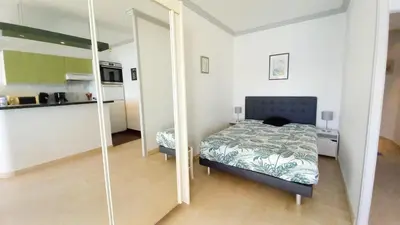 a bedroom with a bed and a mirror at Trident A in Cannes