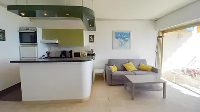 a kitchen and a living room with a couch at Trident A in Cannes