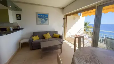 a living room with a couch and a view of the ocean at Trident A in Cannes