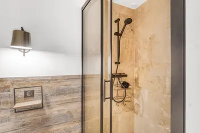 a shower with a glass door in a bathroom at 2 Chambre L - Ascenseur - Proche palais - Calme in Cannes
