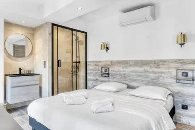 a white bedroom with two beds and a mirror at 2 Chambre L - Ascenseur - Proche palais - Calme in Cannes