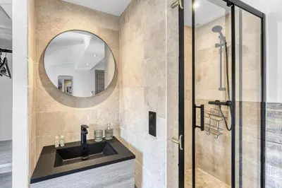 a bathroom with a sink and a mirror at 2 Chambre L - Ascenseur - Proche palais - Calme in Cannes