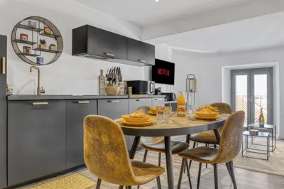 a kitchen and dining room with a table and chairs at 2 Chambre L - Ascenseur - Proche palais - Calme in Cannes