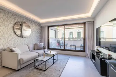 a living room with a couch and a table at Superb One bedroom flat and terrace - Cannes center in Cannes