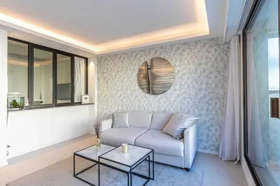 a living room with a couch and a table at Superb One bedroom flat and terrace - Cannes center in Cannes