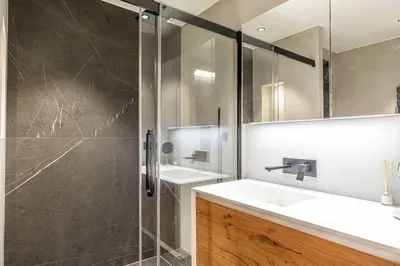a bathroom with a sink and a glass shower at Superb One bedroom flat and terrace - Cannes center in Cannes