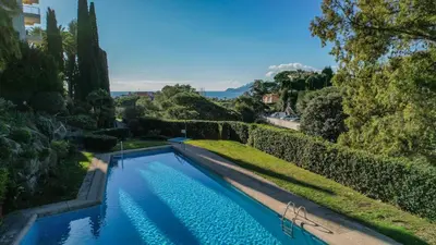 a swimming pool in the middle of a yard at Sublime appartement vue mer in Cannes