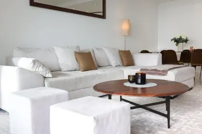 a living room with a white couch and a coffee table at Sublime appartement vue mer in Cannes