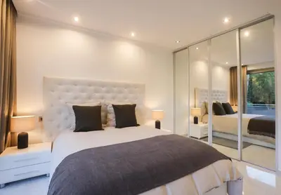 a bedroom with a large bed and a large window at Sublime appartement vue mer in Cannes