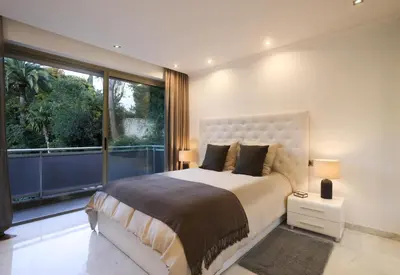 a bedroom with a large bed and a large window at Sublime appartement vue mer in Cannes