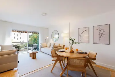 a living room with a table and a couch at Super Californie YourHostHelper in Cannes