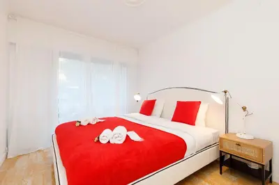 a bedroom with a large bed with two shoes on it at Super Californie YourHostHelper in Cannes