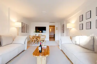 a living room with white couches and a table at Super Californie YourHostHelper in Cannes