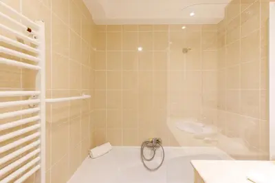 a bathroom with a tub and a sink at Super Californie YourHostHelper in Cannes